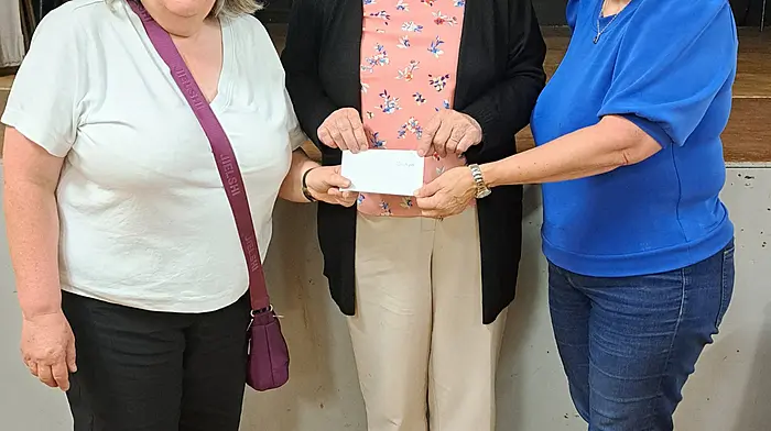 Ann Corcoran (officer, Courcey Rovers) jointly presenting the jackpot cheque to Mary Moloney (Ballinspittle) with Rebecca O'Donovan (chairperson, Ballinspittle Community Centre) at the final bingo night of the summer.