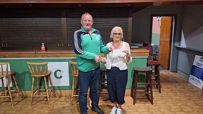 Doheny GAA club chairman Mark Farr presenting a cheque to Sandra Murphy on behalf of her daughter Triona Murphy, East Green, who won the €5,400 Doheny/Sam Maguire lotto jackpot Monday August 24th.