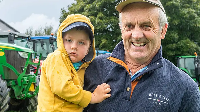 Rossmore, West Cork, Ireland. 30th Aug, 2026. The annual Rossmore Tractor Run took place today in mixed weather. The run was in aid of Cork Arc Cancer Support House Bantry and PosAbilities Autism Centre, Skibbereen. Taking in all the tractors at the run was Rowan Dullea with his grandad Michael, both from Rossmore. Picture: Andy Gibson.