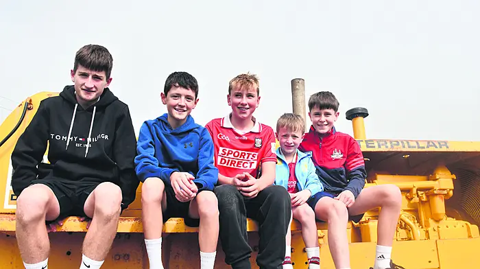 Taking a time out on top of a 1958 Caterpillar D8 H at Tragumna Threshing were local lads Sé O'Brien (Leap), Danny Holmes and Nevan, Conor and Dylan O'Callaghan, all from Skibbereen.   (Photo: Anne Minhane)