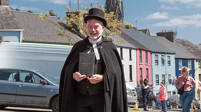 Reverend Andrew Coleman during the Bandon Walled Festival’s historical parade holding the original Book of Common Prayer which was printed specifically in 1899 for the Clergy of Christ Church located in Kilbrogan Street, Bandon. It was printed ahead of the church’s anniversary celebrations . Christ Church was built in 1610 and was deconsecrated and closed in 1973.  Photo courtesy of Dan Holland.