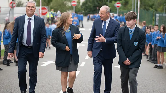 An Taoiseach Micheál Martin TD walking with principal Fergal McCarthy, head girl Muireann O’Donovan and head boy Jack O’Leary during a visit to Kinsale Community School to turn the sod on a new €22 Million extension.  (Photo: John Allen)