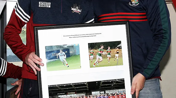 Vice-chairman of Clonakilty GAA underage club Tomás Hayes makes a presentation to Cork minor footballer Fionn O'Donovan.  (Photo: Paddy Feen)