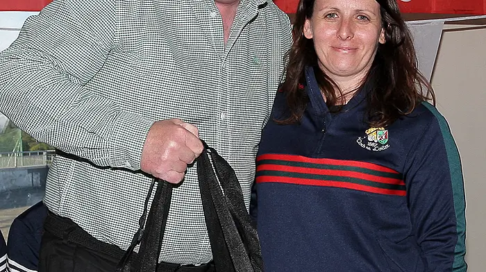 Clonakilty GAA Childrens Officer Sharon Drumm makes a presentation to Keith Ricken, manager of the Cork minor football team.  (Photo: Paddy Feen)