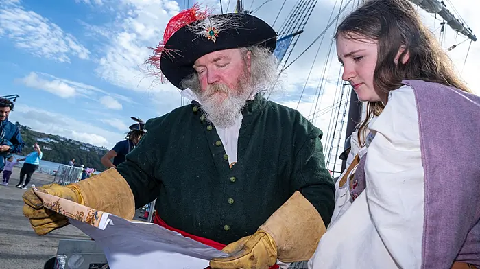 REPRO FREETomás Ó Brógáin and Tegan Flynn Smyth from Oireas Historical Services, pictured next to a recreation of a Spanish galleon, were some of the re-enactors in Kinsale to commemorate the Battle of Kinsale 425 years ago.Picture. John AllenKinsale Society Earns Top Marks for Siege and Battle CommemorationsKinsale Cultural and Heritage Society received top marks for their commemoration efforts for Kinsale’s Siege and Battle in the town on Saturday last.Almost 425 years to the day that the Spanish forces landed in Kinsale to aid the Gaelic lords engaged in their nine‑years’ war, having inflicted several defeats on the Crown forces, including a victory at the Battle of the Yellow Ford, Kinsale played host to a Spanish Galleon once more.Acknowledging the importance of the replica of Christopher Columbus’s Nao Santo Maria docking in the port to mark the commemorations, Chairperson of the society, JJ Hurley, praised the efforts of all those involved in securing the vessel over the weekend.‘There is little doubt the ship has been a central point for our efforts to commemorate the important historical event this weekend, but without the work of our secretary, Fergal Browne, this would never have happened,’ he said.‘I would also pay tribute to Cork County Council Official Brian Dunne, as well as Cllrs Alan Coleman and Marie O’Sullivan, who were also instrumental.‘Of course, our friends at the Nao Victoria Foundation, who operate the ship, were outstanding in finding a window to fit us in.’In addition to the large crowds coming to the town to view the ship, members of the public also had the opportunity to review military uniforms, weapons and practices, with members of Lord Edwards Own Reenactment Group playing a central role.Included in this line‑up was a march from the historic Galleon, preceded by Tomás Ó Brógán delivering a proclamation to the people of Kinsale, first delivered by the commander of Spanish forces in 1601, Don Juan del Aguila, promising to bring no harm to the people of the town.Brógán later delivered a demonstration and talk on military weapons and tactics to a large gathering at Short Quay, before the reenactors completed a march around the environs of the historic town.Praising the efforts of the local historical society, Chairperson of the Bandon and Kinsale Municipal Area, Cllr Alan Coleman said, ‘Credit, where credit is due here, Kinsale Cultural and Heritage Society continue to work hard to preserve the history and heritage of the area,’ he said.‘Cork County Council will certainly continue in their efforts to ensure this will continue.‘In addition to strengthening their links with the local authority, it is so important to see UCC also playing a significant part in helping to involve themselves in the commemorations.’Next week the society will welcome Dr Hiriam Morgan, UCC, who has long been a supporter of the efforts to tell the story of the town’s heritage.Joining Dr Morgan at St Multose Church for the history seminar on Saturday, September 26th, are Dr Ruth Canning, Maynooth University, Dr Jim O’Neill, and Dr Igor Perez Tostado, for what promises to be a fascinating day’s lectures on the Siege and Battle of Kinsale and its aftermath.Tickets for this event are available at www.eventbrite.com — search Siege and Battle of Kinsale Seminar.JJ Hurley086 1971870Facebook jjhurleyTwitter KinsaleobserverInstagram KinsaleobserverTikTok Kinsale Observer