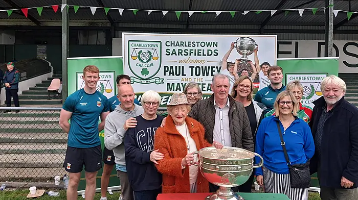 Noreen Minihane, whose father was from Mayo, pictured up in Charlestown, County Mayo with her cousins holding the Sam Maguire Cup.