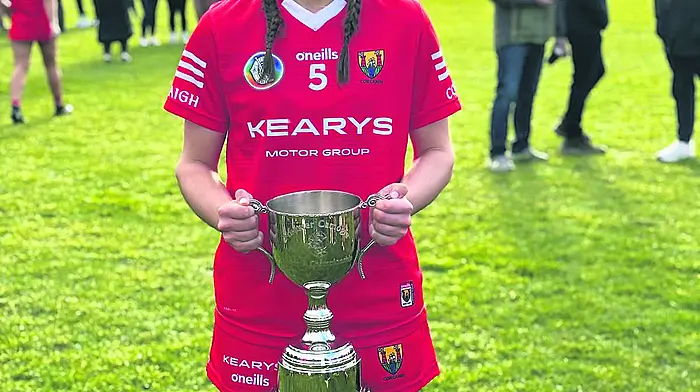 Cliona Harte, Cork minor camogie winner, with the Munster trophy after the game.