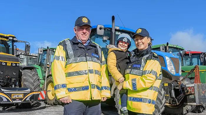 Garda Michael Cadogan (Ballineen) and Garda Trina Collins (Bandon) with Paulie Verling of Newcestown at weekend's tractor run. (Photo: David Patterson)