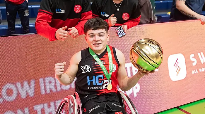 Conor Coughlan with his parents Mary and Con celebrating his success with the Rebel Wheelers.