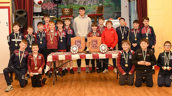 Cork hurling star Brian Hayes of St Finbarr's pictured with the smiling Timoleague U12 team at their medal presentation at Timoleague Community Hall.