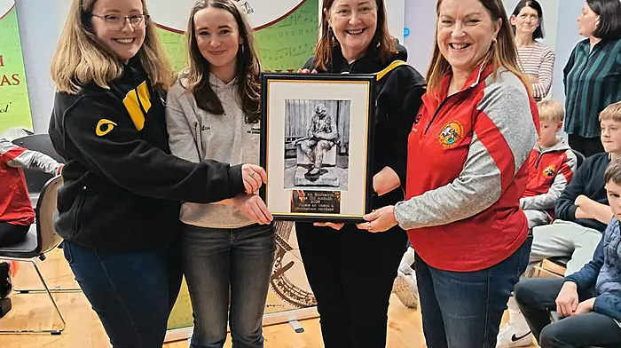 Martina French (right)  and Lisa O'Mahony, Skibbereen Comhaltas, presenting a gift to Attracta O’Brady and her daughter Róisín, Killeigh Branch.