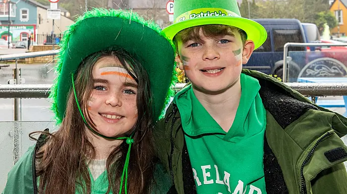 Bantry, West Cork, Ireland. 17th Mar, 2026. A huge number of people turned out for the Bantry St. Patrick's Day parade, despite the wet weather. Grand Marshall for the event was Graham Canty, the Cork GAA Footballing legend. Enjoying the Bantry St. Patrick's Day parade were Indie & Jayden O'Sullivan from Durrus. Picture: Andy Gibson.