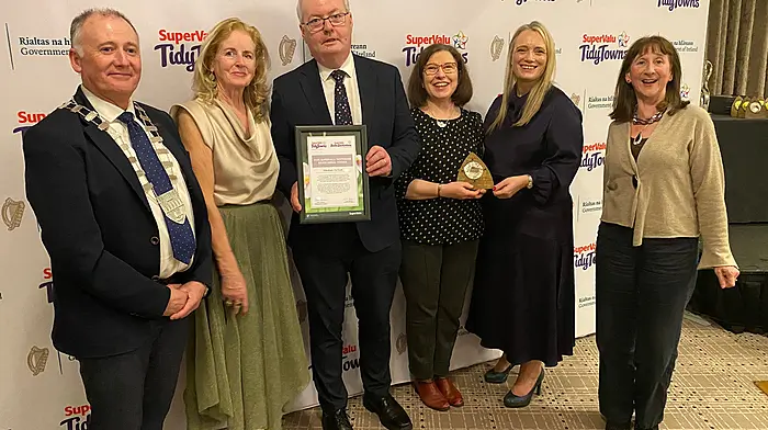 Kilbrittain Tidy Towns volunteers Helen Cashman, Sinead Moloney and Anne Bradfield accepting the silver medal won in the 2025 Tidy Towns competition at the Regional Awards Ceremony in Tralee.