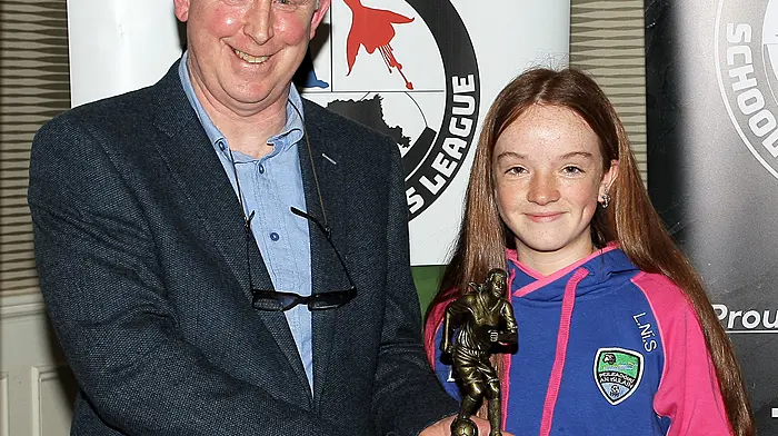 Sullane's Lily Scannell, crowned U14 Girls Player of the Year, receives her award from Declan Deasy. (Photo: Paddy Feen)