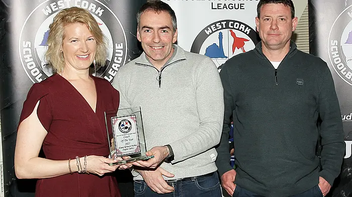 Tadhg Curtin, WCSSL treasurer, presents the 2025 Coach of the Year award to joint winners, Eileen and Kevin Hurley (Togher Celtic). (Photo: Paddy Feen)