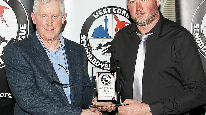 Declan Deasy, WCSSL Chairman, presents the 2025 Club of the Year award to Beara United chairperson Michael John Hanley. (Photo: Paddy Feen)