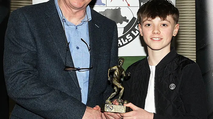2025 Academy U12 Player of the Year Daniel Brady receives his award from Declan Deasy. (Photo: Paddy Feen)