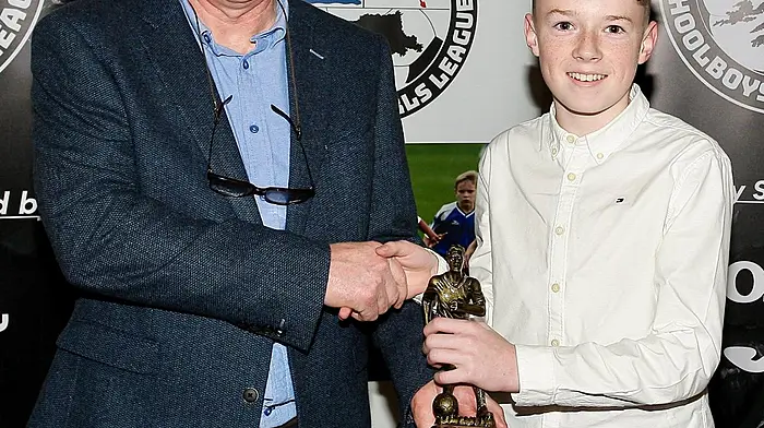 Sonny Crowley (Lyre Rovers FC) receiving the WCSSL U12 Player of the Year award from Declan Deasy at the recent WCSSL awards night at the Celtic Ross Hotel. Photo courtesy of Paddy Feen.
