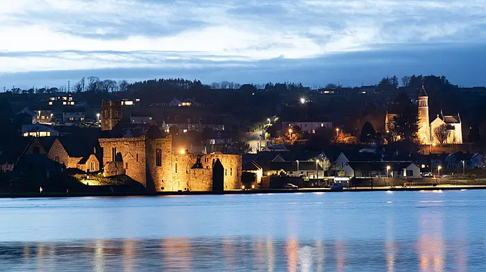Evening time in Timoleague dominated by the floodlit Timoleague Friary which was founded by the Franciscan Order in 1240 and The Church of the Nativity of the Blessed Virgin Mary which was opened in September 1912.   (Photo: Martin Walsh)