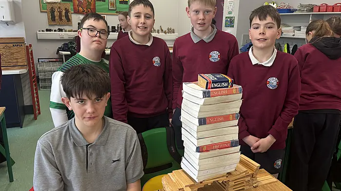 Rowan O’Neill, James Hurley, William O’Neill, Ian Fitzgerald and Max Musgrave testing the strength and span of their bridge during Engineer’s Week at Rath National School.