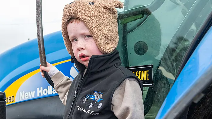 Crookstown, West Cork, Ireland. 22nd Mar, 2026. A charity tractor, car & motorbike run was held in Crookstown today to raise funds for a defibrilator for the village. Taking in all the tractors on display was 4-year-old Caelan Lucey from Enniskeane. Picture: Andy Gibson.