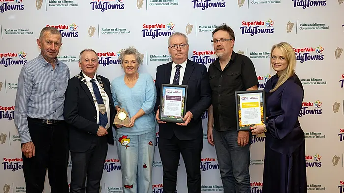 Clonakilty Tidy Town members Mike Deasy, Roni Coomey and Diarmuid Cregan accepting their 26th gold medal, with 21 of these medals being in a row, at the recent celebration at the Rose Hotel, Tralee.
