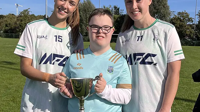 James Hurley with his sister Emma and her teammate Michelle Collins celebrating the Ilen Rovers junior ladies county win last Saturday.