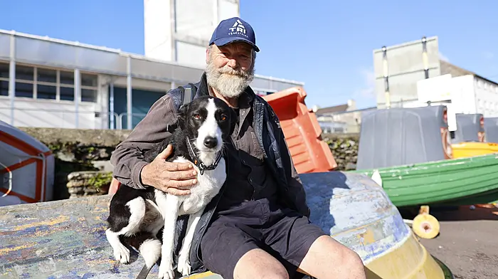 Eoin Davis and his faithful four-legged companion, Broc, soak up the sunshine at the pier in Schull. Photo by Carlos Benlayo