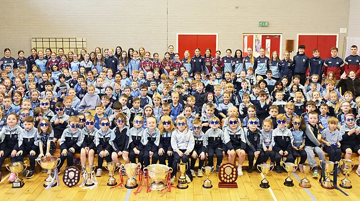 Pupils of Barryroe National School with Cork minor footballers Conrad Murphy and Riley O'Donovan and members of successful Barryroe and Ibane Gaels and Ibane LGFA teams that brought their winning silverware to the school last Tuesday morning.  (Photo: Martin Walsh)