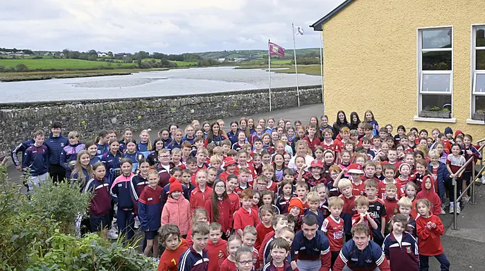 Cork minor footballers Conrad Murphy and Riley O'Donovan and members of successful Ibane Gaels, Ibane LGFA and Barryroe camogie teams on a visit to Timoleague National School last Tuesday.    (Photo: Martin Walsh)