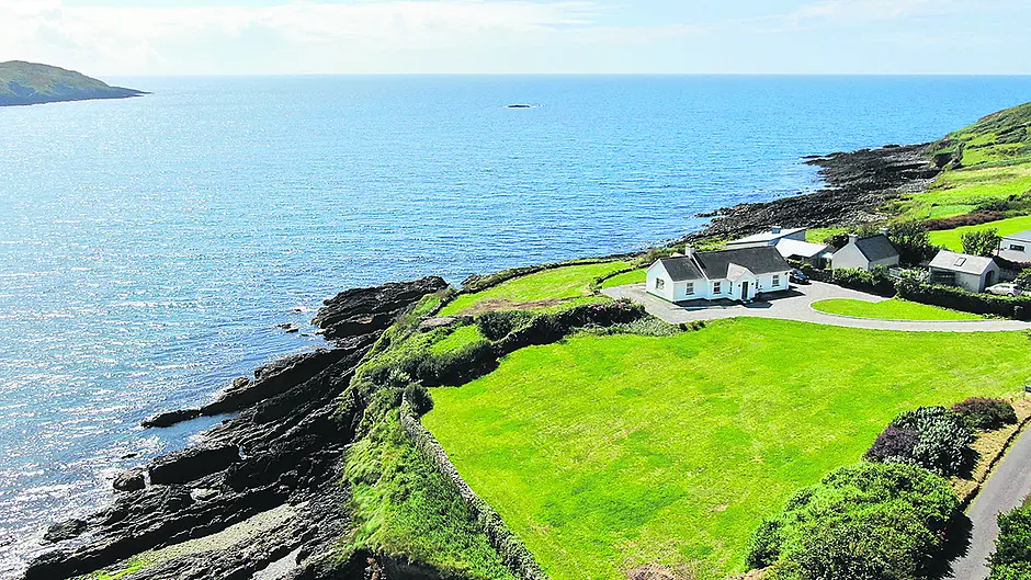 Coastal bungalow has pebble beach and secret garden Image