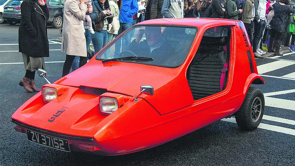 Ken snug in his beloved tangerine bug Image