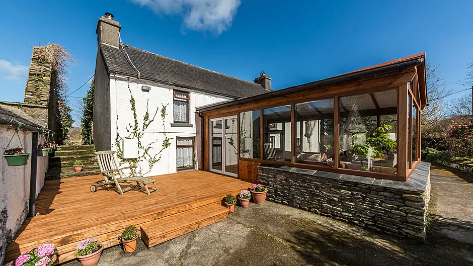 The house is a large family home, with an impressive kitchen, south-facing 
conservatory, double garage and also a delightful garden which boasts a stream and stone steps that lead to a number of 
delightful reading areas.