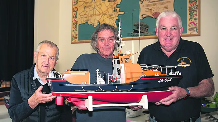 Modelmaker Alan Wilson (centre) with a model of the Waveney class lifeboat RNLB Arthur and Blanche Harris that was stationed in Courtmacsherry from 1993 to 1995. (Photo: Martin Walsh)