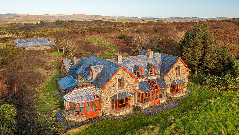 There’s a rustic charm to the interior of the property which features extensive wood panelling. The large and detached garage, left, will be another strong selling point.