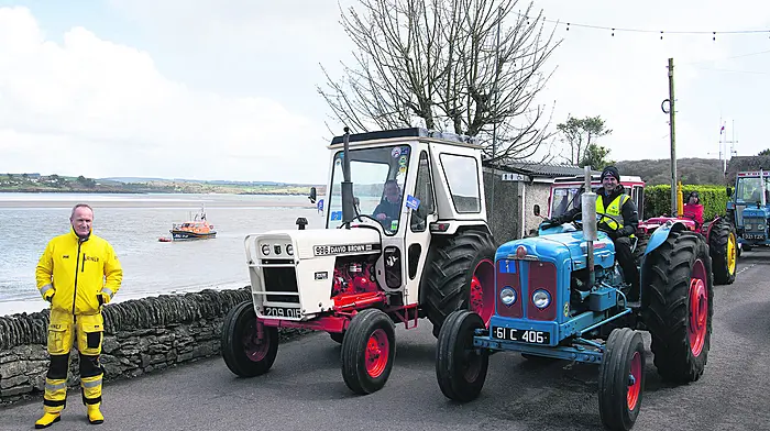 The vintage tractors of Denis Ryan (David Brown) and John Fleming (Fordson Supermajor) stopped in Courtmacsherry against the backdrop of the new Shannon-class lifeboat the RNLB Val Adnams during the car, truck, tractor and motorcycle run on Easter Monday in aid of the Courtmacsherry and Kinsale lifeboat stations. They were joined by Denis Murphy of the Courtmacsherry RNLI. (Photo: Martin Walsh)