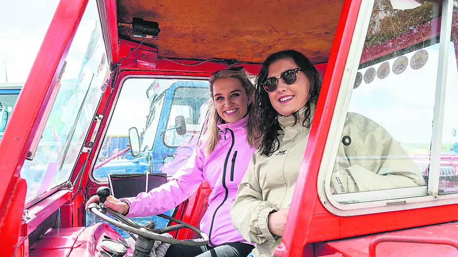 Grace Ryan, Innishannon and Catherine Lordan, Enniskeane, enjoying the sunshine before taking part in the Tractors To The Rescue, Courtmacsherry to Kinsale RNLI tractor run, in a Massey Ferguson 133. 	    	                    (Photo: David Patterson)