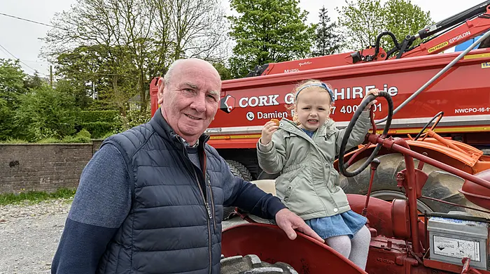 Teddy Crowley with grandaughter Elimay Crowley, Innishannon at the Hamilton High School tractor, truck and car run. Proceeds of the run will go to the school development fund and to Darkness into Light. Right: Ger and Denis Cummins, Bandon) supporting the fundraiser. (Photos: David Patterson)