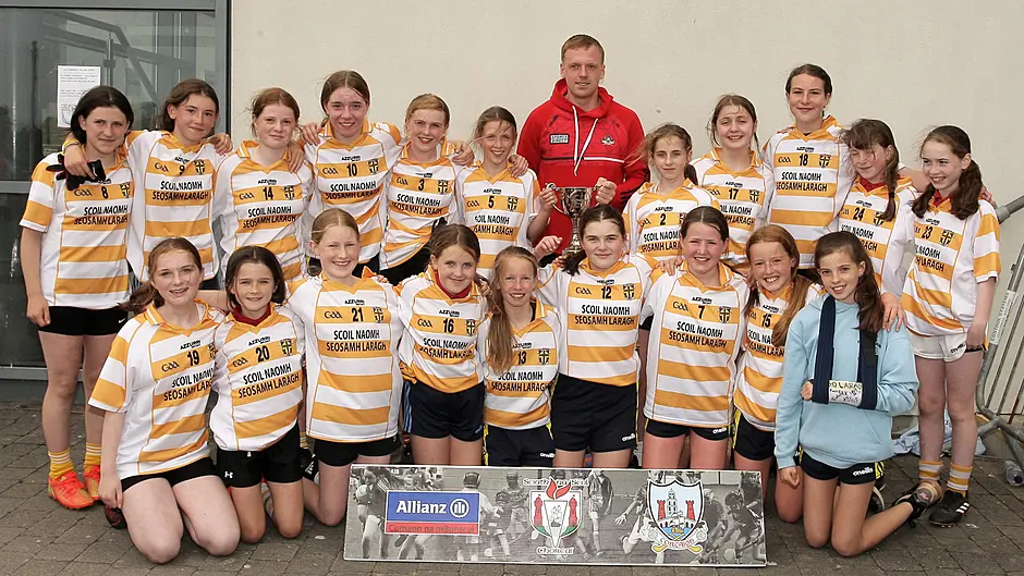 Scoil Naomh Seosamh, Laragh, Roinn 2 Girls (13-a-side) winners. were presented with the trophy by Cork star Luke Meade. (Photo: Paddy Feen)