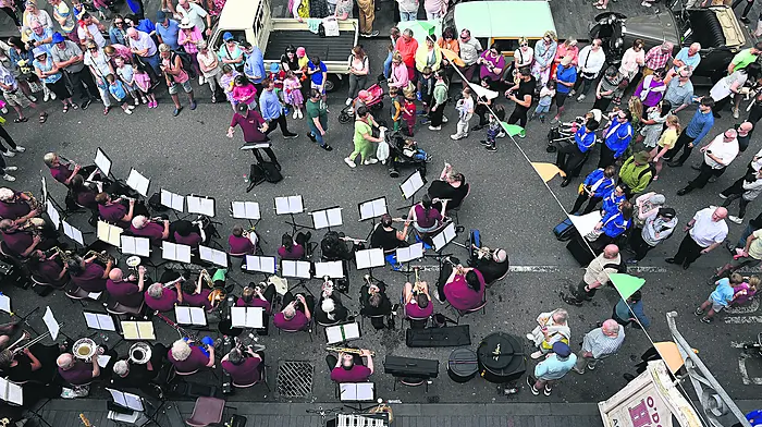 IN THE MOOD: Revellers enjoy the musical entertainment outside O’Donovan’s Hotel during the Clonakilty Old Time Fair and South of Ireland Band Championships which took place in the town last weekend.                                           (Photo: Martin Walsh)