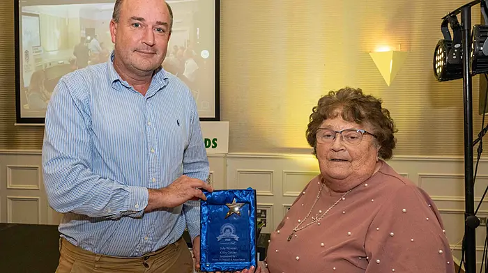 Kitty Cotter collects the July award presented by Donal McCarthy of Owen O'Driscoll and Associates.