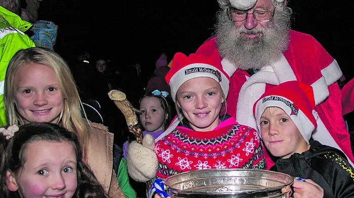 Union Hall. Saturday 02nd December 2023The Christmas Light switch on took place in Union Hall on Saturday evening. The event was marked by the arrival of Santa with the Andy Scannell Cup, carols were sung by children from the Union Hall National School Choir and hot drinks were served to all to ward of the cold.Here: Milly, Ruby, Zach and Sophia O' Donoghue With Santa and Andy Scannell CupCredit: Andrew Harris.